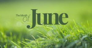 A photo of green grasses withthe words The Month of June printed over the photo